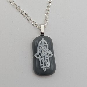 Hand crafted artisan made grey glass Israel support Hamsa handwritten necklace.